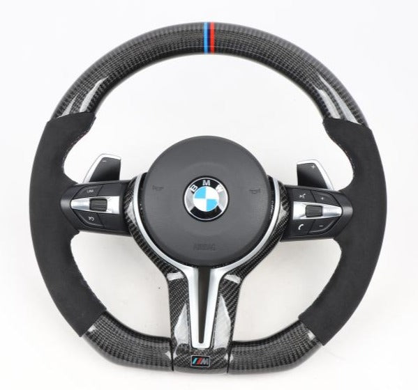 Close Up View of a BMW M Logo on Black Leather Steering Wheel